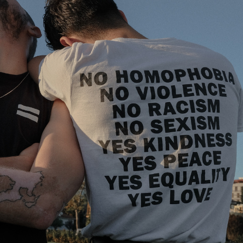 Man with back facing wearing a shirt that reads "no homophobia, yes equality"